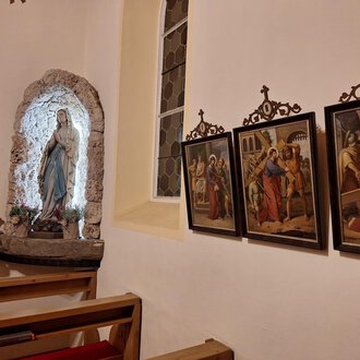 A church gallery with a statue of Mary and several historical paintings on the wall. The atmosphere is peaceful and reverent. | © Unterwestegg-Kapelle Maria Hilf | Tanja Ritsch