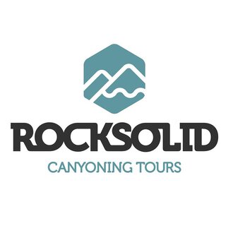 A logo of "Rocksolid Canyoning Tours". It features stylized mountains and water waves in a modern font.